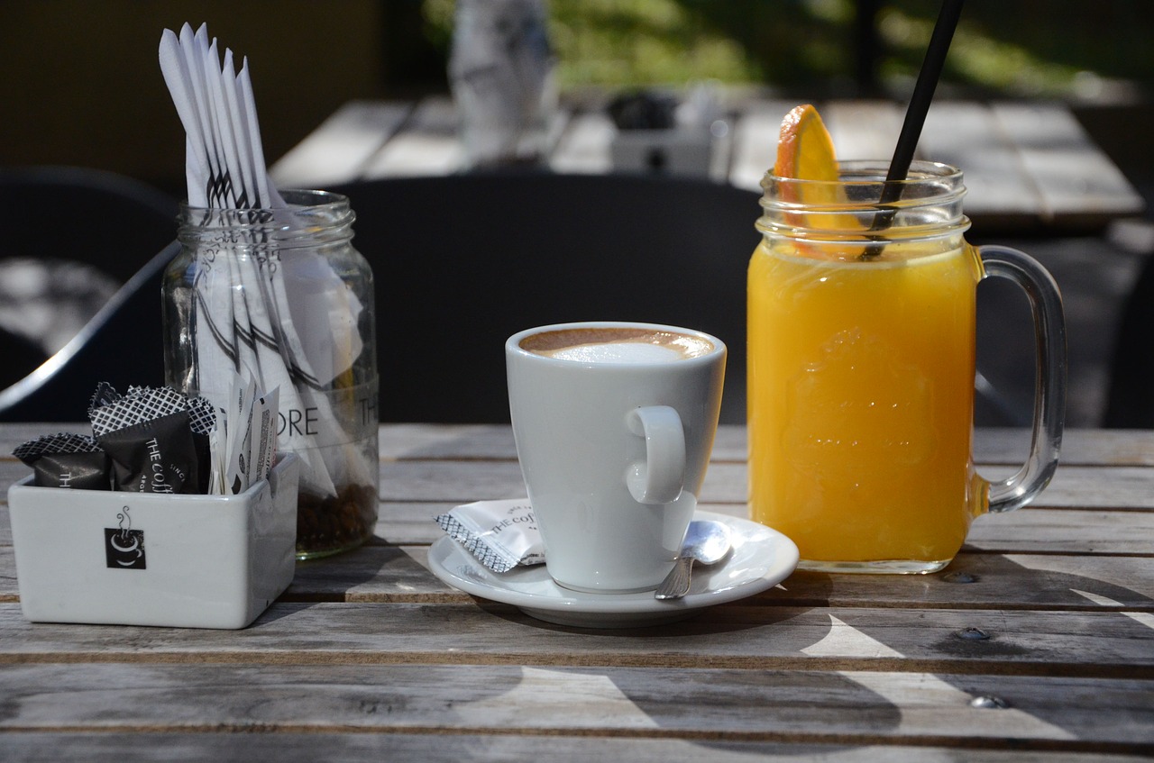 A table with orange juice and coffee on it.