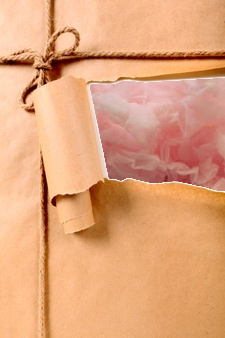 A torn parcel revealing pink ruffled fabric