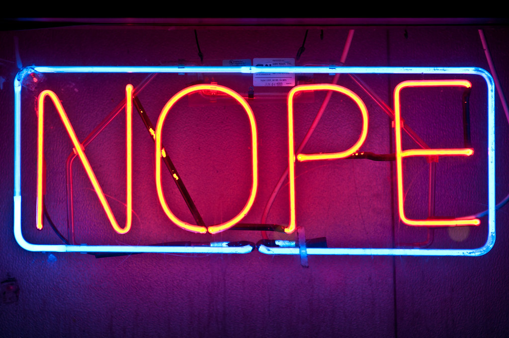 Neon sign reading "NOPE"