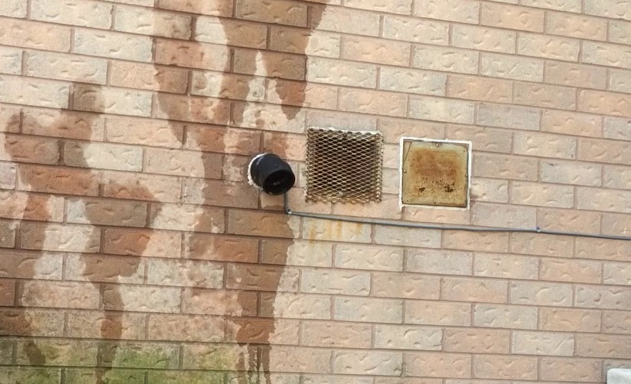 A brick wall with liquid running down it