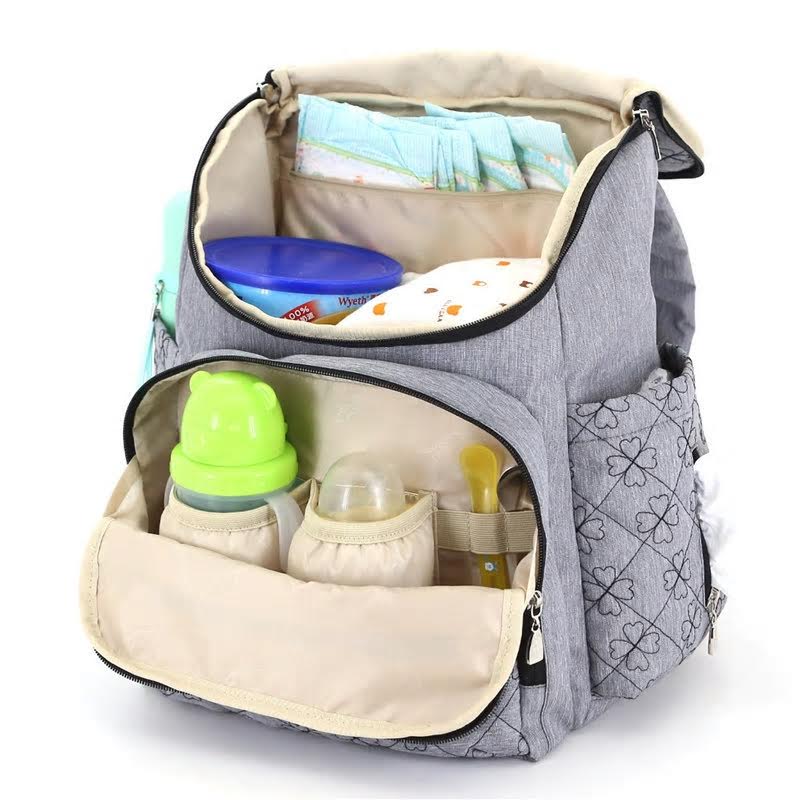 Nappy bag containing baby bottles, nappies and formula.
