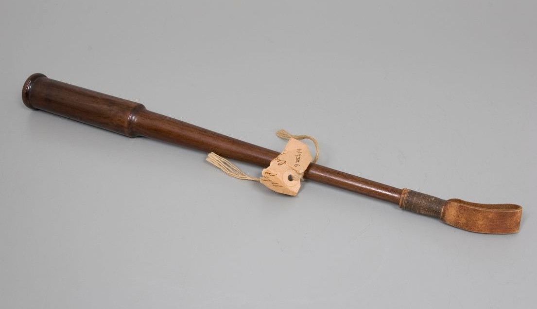 A vintage brown leather riding crop