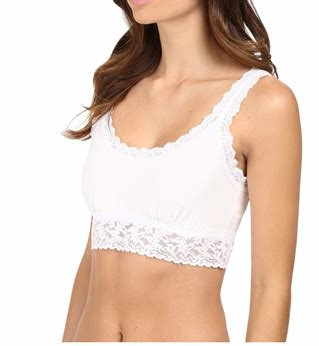 A woman with long brown hair in a white cotton croptop.