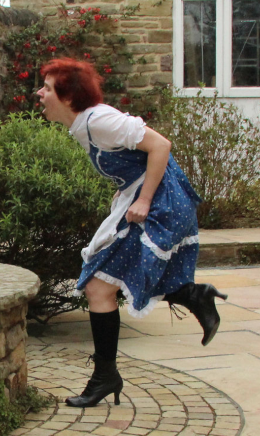 An outraged girl running in a blue and white dress