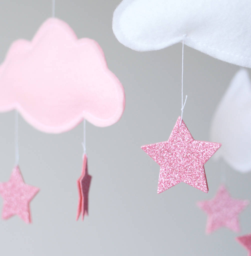 A baby's crib mobile featuring sparkly pink stars and fluffy clouds